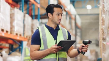 amazon employee in a warehouse holding a tablet