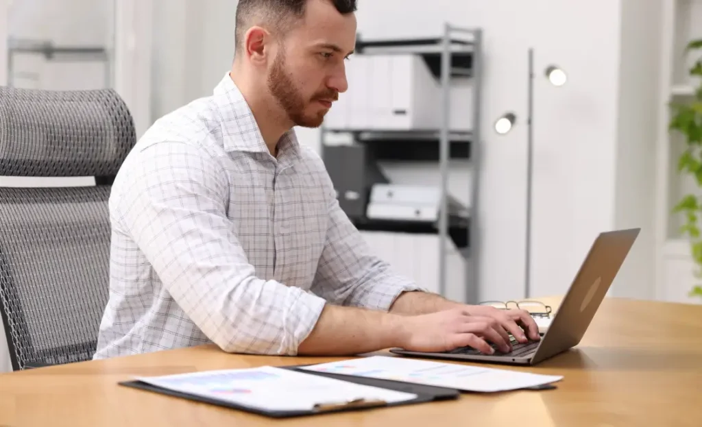 man at a laptop in an office