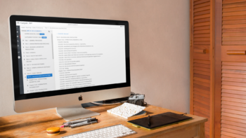 iMac computer and keyboard on a wooden desk