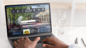 Laptop displaying the website homepage of Roswell, GA