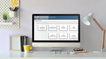 Desktop computer and reading lamp on a white desk