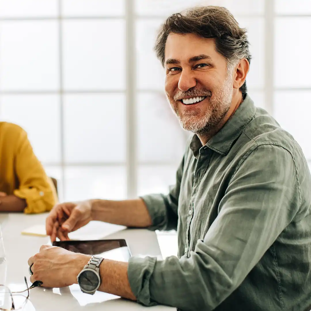 Man smiling in a meeting