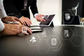 People looking at a computer at a desk with digital imagery overlayed.