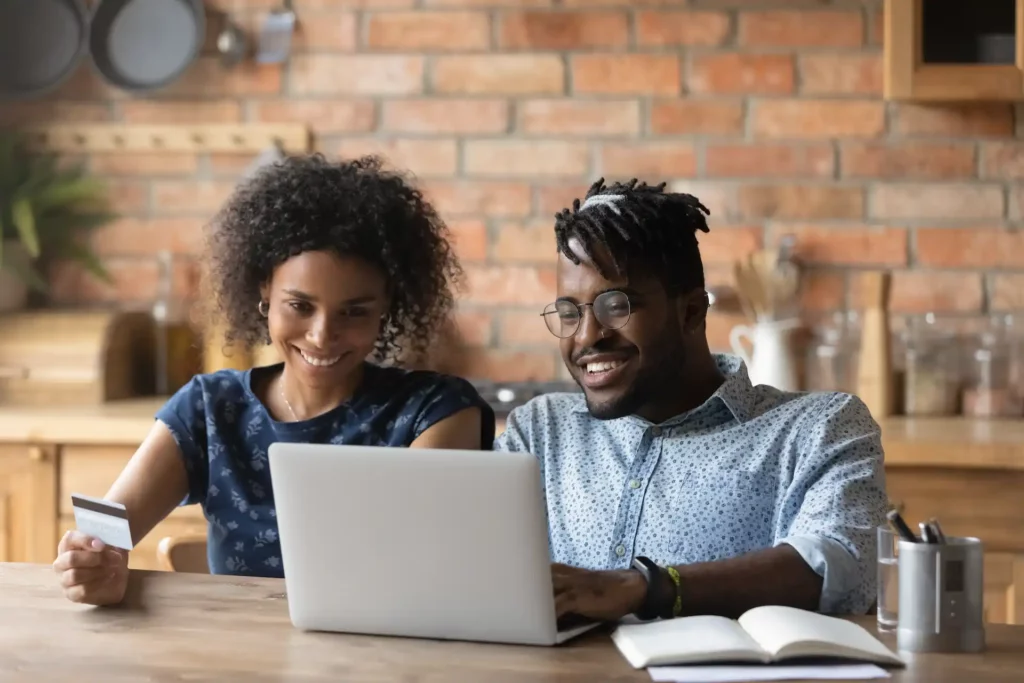 Peopele looking at a laptop together