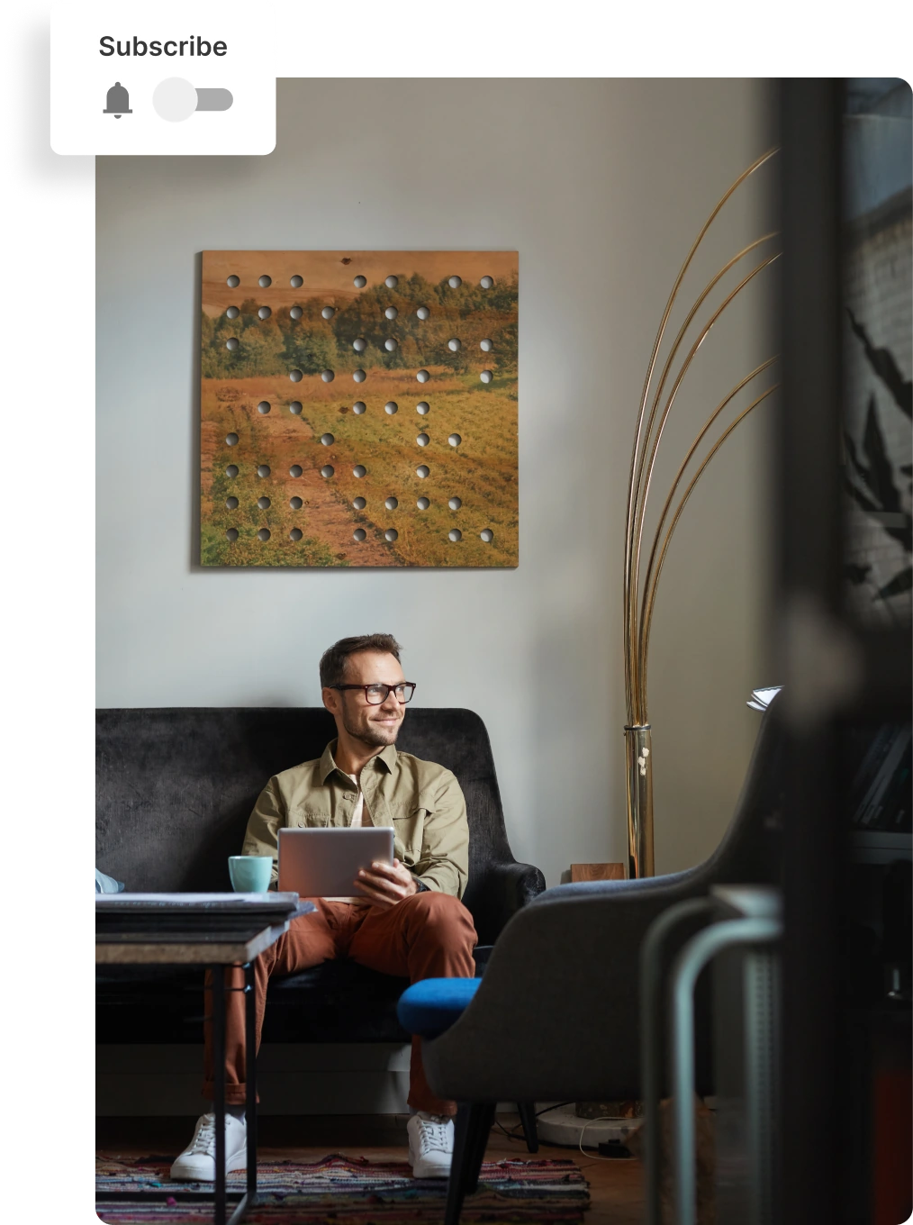 A person sitting on a couch with a tablet in their hands.